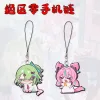 Mini chibi acrylic Zenless Zone Zero phone charms showing green-haired character Sunna crouching down and a pink character screaming on a black cord loop strap.
