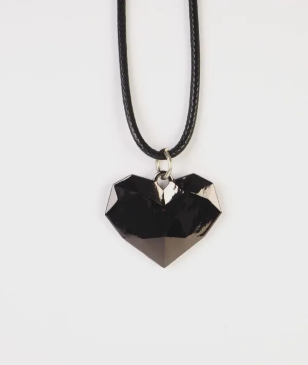 A premium faceted black heart pendant necklace for Zenless Zone Zero character Nicole Demara, featuring an 11.6g geometric resin crystal on a black braided cord.
