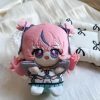 A 10cm sitting chibi plush keychain of Nicole Demara from Zenless Zone Zero, featuring pink hair with a blue streak, large embroidered eyes, and a blue halo accessory on the back.