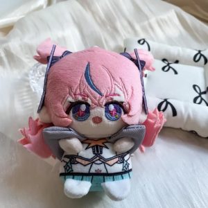 A 10cm sitting chibi plush keychain of Nicole Demara from Zenless Zone Zero, featuring pink hair with a blue streak, large embroidered eyes, and a blue halo accessory on the back.