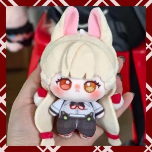 A person holding a 10cm plush cotton doll of the fan-made anime character Alice from Zenless Zone Zero. The chibi doll has blonde hair, fluffy bunny-like ears, large embroidered amber eyes, and wears a white shirt with dark shorts.