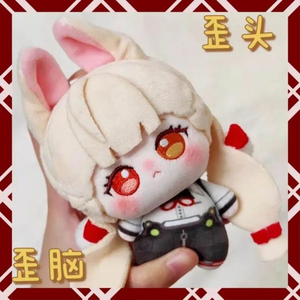 A person holding a 10cm plush cotton doll of the fan-made anime character Alice from Zenless Zone Zero. The chibi doll has blonde hair, fluffy bunny-like ears, large embroidered amber eyes, and wears a white shirt with dark shorts.