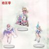 A collection of three clear acrylic standees featuring Zenless Zone Zero anime characters, including a pink-haired girl with wings, a blonde girl with a spiked bat, and a blonde girl with a blue lance. They are displayed on clear circular bases against a light, watercolored background.