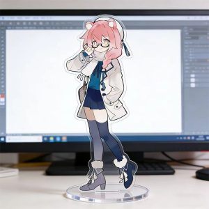 Clear acrylic desktop standees of cute Zenless Zone Zero characters in casual clothing standing on round transparent bases, displayed in front of a computer monitor on a desk.