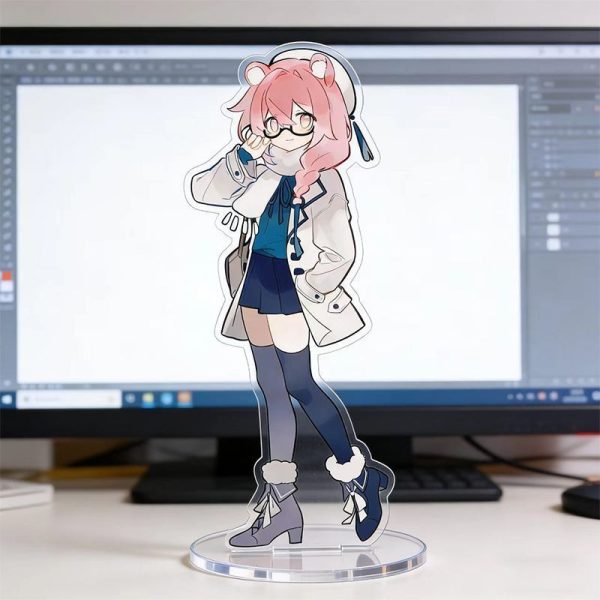 Clear acrylic desktop standees of cute Zenless Zone Zero characters in casual clothing standing on round transparent bases, displayed in front of a computer monitor on a desk.