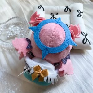 A 10cm sitting chibi plush keychain of Nicole Demara from Zenless Zone Zero, featuring pink hair with a blue streak, large embroidered eyes, and a blue halo accessory on the back.