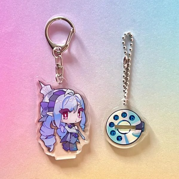 Two clear acrylic anime keychains featuring chibi versions of Hugo and Vivian from Zenless Zone Zero. The characters are shown both lying flat as keychains with metal clasps and slotted into their round rotary dial bases to stand upright as mini figures.