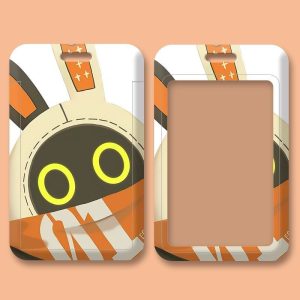 Two variations of a sliding hard-shell card holder featuring the Eous Bangboo from Zenless Zone Zero. One shows its classic yellow eyes, while the other displays the word "FAIRY" across its face. Both feature a clear transparent window on the back for securely displaying ID cards.