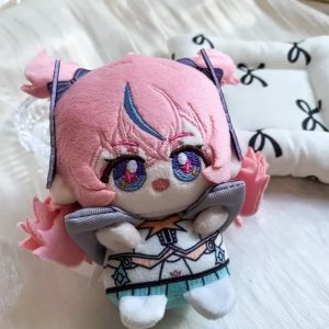 A 10cm sitting chibi plush keychain of Nicole Demara from Zenless Zone Zero, featuring pink hair with a blue streak, large embroidered eyes, and a blue halo accessory on the back.