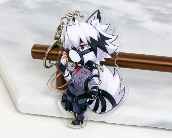 A clear acrylic keychain resting on a white marble surface, featuring a chibi anime illustration of the white wolf character Von Lycaon from Zenless Zone Zero wearing a suit and holding a pocket watch.
