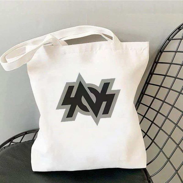 White canvas tote bag printed with Zenless Zone Zero Bangboo artwork and Z.Z.Z text resting on a chair.
