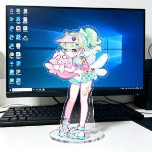 Zenless Zone Zero acrylic standees featuring three anime characters in pastel swimsuits with summer accessories standing in front of a computer screen.