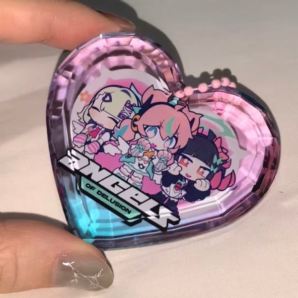 Selection of Zenless Zone Zero Angels of Delusion acrylic keychains, including a faceted heart-shaped gem block, a die-cut charm with a dangling logo, and a pink clasp keyring.