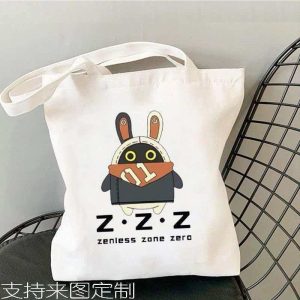 White canvas tote bag printed with Zenless Zone Zero Bangboo artwork and Z.Z.Z text resting on a chair.