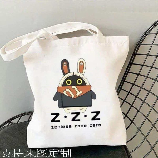 White canvas tote bag printed with Zenless Zone Zero Bangboo artwork and Z.Z.Z text resting on a chair.