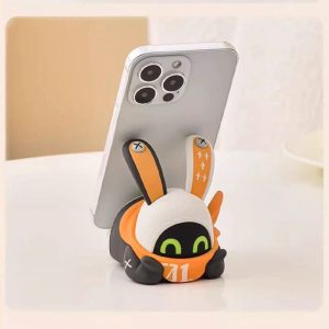Cute Zenless Zone Zero Eous Bangboo soft silicone figure holding a smartphone horizontally on a white desk.