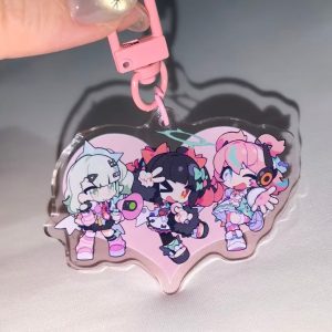 Selection of Zenless Zone Zero Angels of Delusion acrylic keychains, including a faceted heart-shaped gem block, a die-cut charm with a dangling logo, and a pink clasp keyring.