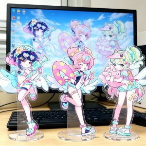 Zenless Zone Zero acrylic standees featuring three anime characters in pastel swimsuits with summer accessories standing in front of a computer screen.